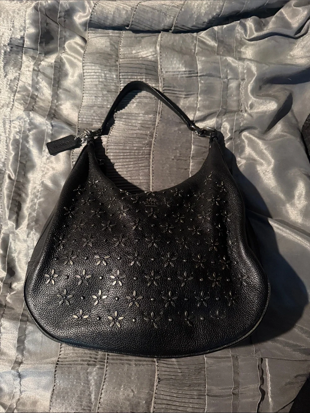 Coach leather hobo bag decorated with floral prairie rivets